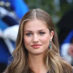 La principessa Leonor, con i suoi occhi azzurri e i capelli biondi, sorride con un elegante orecchino.