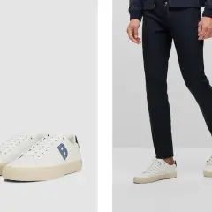 Outfit elegante con sneakers uomo: pantaloni blu scuro e scarpe bianche con logo blu.