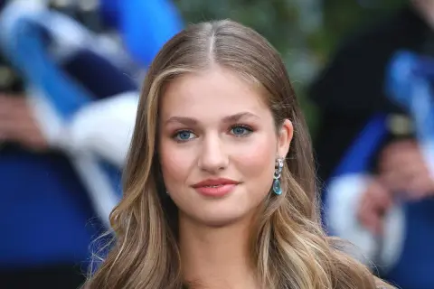 La principessa Leonor, con i suoi occhi azzurri e i capelli biondi, sorride con un elegante orecchino.