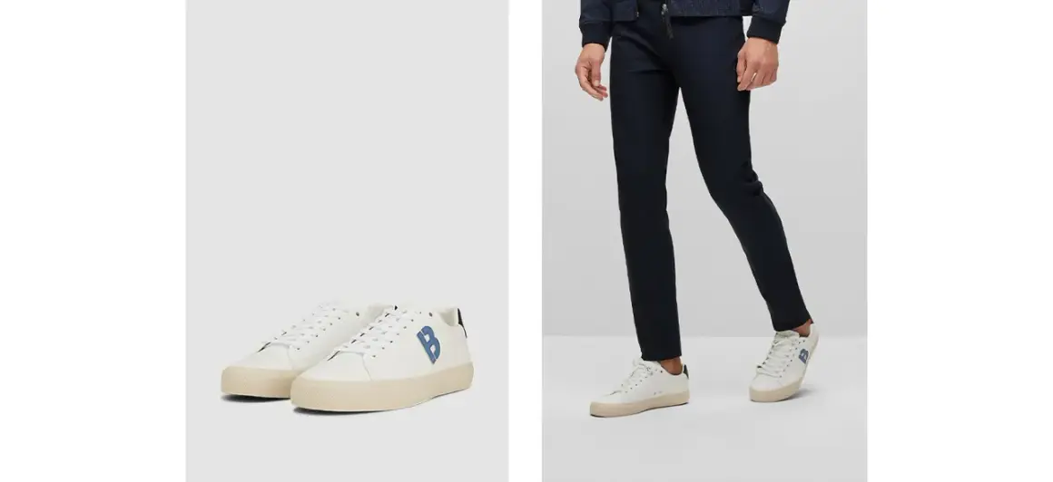 Outfit elegante con sneakers uomo: pantaloni blu scuro e scarpe bianche con logo blu.