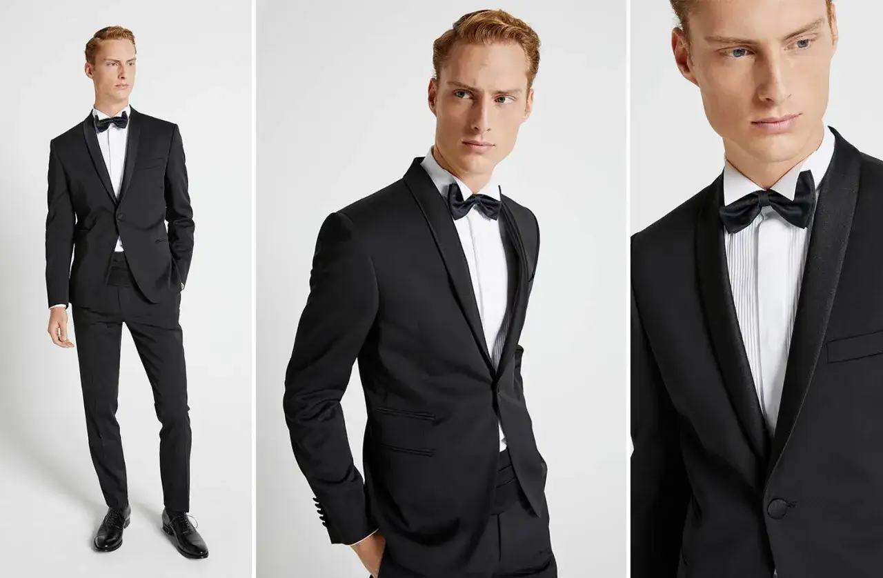 Modello indossa un completo nero con papillon, pronto per un evento speciale. La camicia diplomatica è impeccabile.