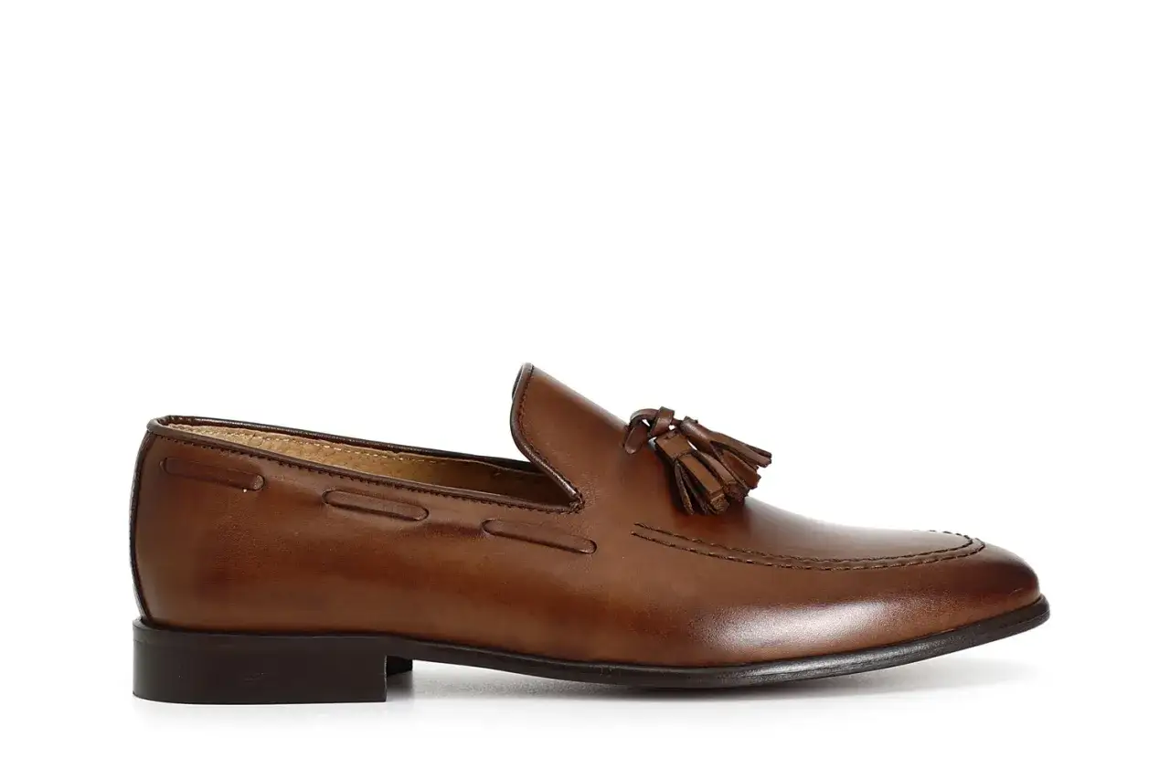 Mocassino da uomo in pelle marrone con nappine, un classico tra i tipi di mocassini eleganti.