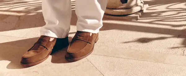 Eleganza casual: mocassini marroni uomo abbinamento perfetto con pantaloni chiari per un look raffinato sotto il sole.
