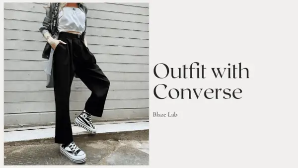 Outfit con Converse alte a righe, pantaloni neri ampi e top bianco. Ecco come allacciare le Converse alte per un look audace.