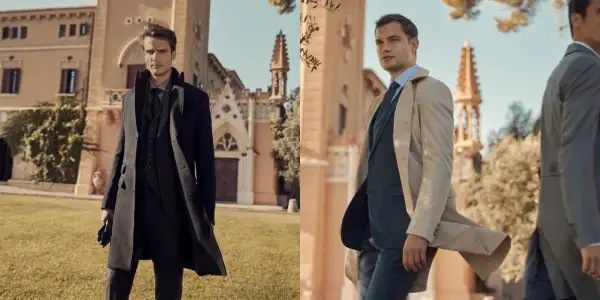 Uomo elegante con cappotto nero e completo grigio. La lunghezza cappotto uomo è perfetta per un look sofisticato.